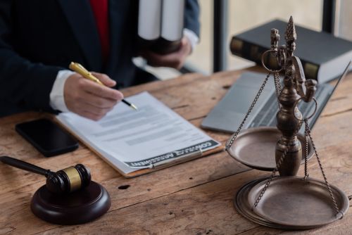 Male business man lawyers working with contract papers at the law firms. Judge gavel with scales of justice. Legal law, lawyer, documents, advice and attorney, court judge, concept.
