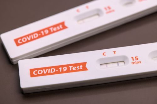Used iHealth COVID-19 Test home Coronavirus testing kit with positive and negative result. Isolated cut out background healthcare product.